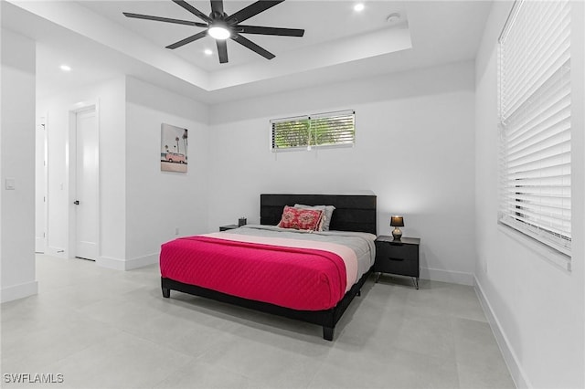 bedroom with recessed lighting, a raised ceiling, and baseboards