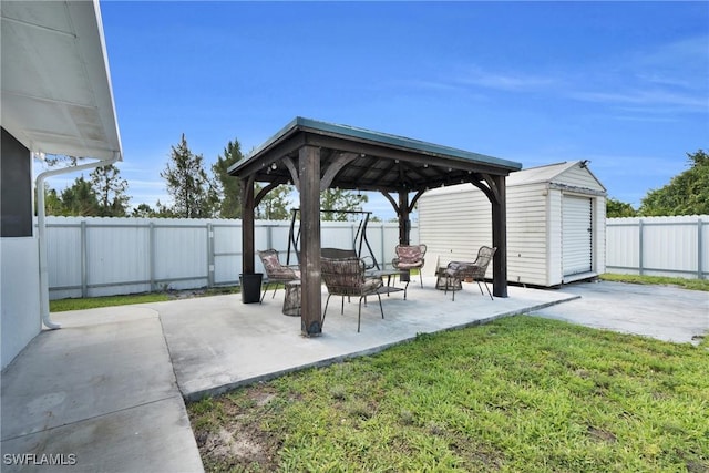 view of patio / terrace with a gazebo, an outdoor structure, and a storage unit