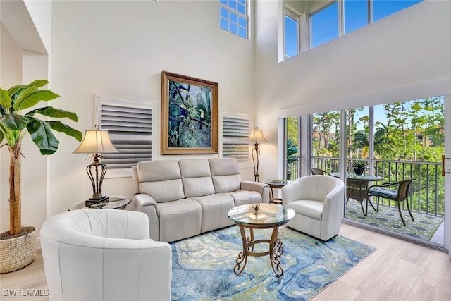 4500 Botanical Place Cir Unit 301, Naples, FL 34112 - living area with a high ceiling and wood finished floors