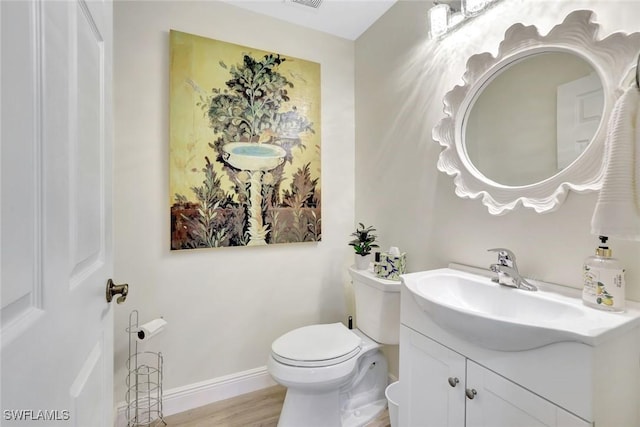 4500 Botanical Place Cir Unit 301, Naples, FL 34112 - half bath with vanity, baseboards, toilet, and wood finished floors