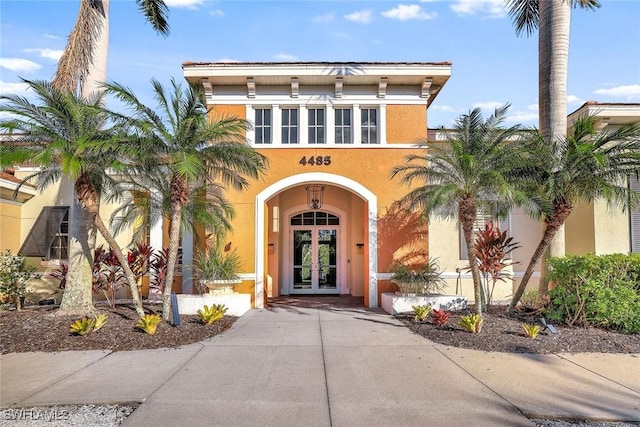 4500 Botanical Place Cir Unit 301, Naples, FL 34112 - entrance to property with stucco siding and french doors