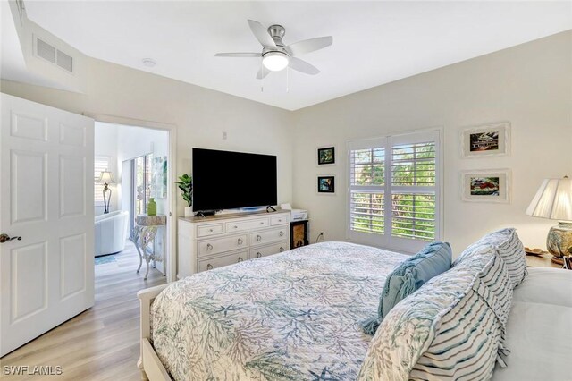 4500 Botanical Place Cir Unit 301, Naples, FL 34112 - bedroom with visible vents, a ceiling fan, and light wood finished floors