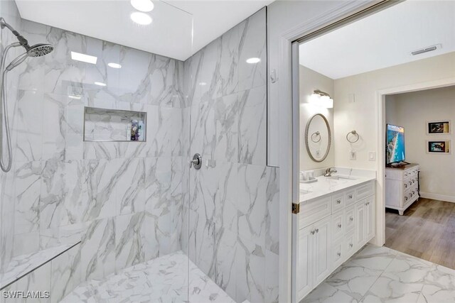 4500 Botanical Place Cir Unit 301, Naples, FL 34112 - full bath featuring visible vents, double vanity, marble finish floor, a sink, and a marble finish shower