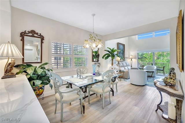4500 Botanical Place Cir Unit 301, Naples, FL 34112 - dining area featuring an inviting chandelier, plenty of natural light, and light wood-type flooring