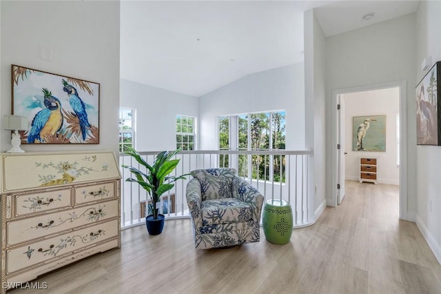 4500 Botanical Place Cir Unit 301, Naples, FL 34112 - sitting room with light wood-type flooring, baseboards, and vaulted ceiling