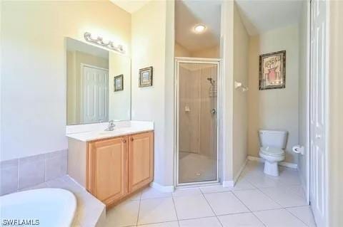 3919 Aurora Ct, Naples, FL 34116 - full bath featuring a stall shower, vanity, tile patterned flooring, and a garden tub