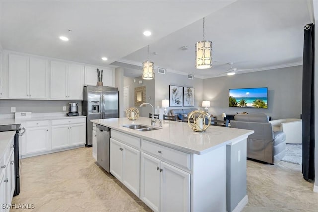 kitchen featuring visible vents, crown molding, open floor plan, a sink, and appliances with stainless steel finishes