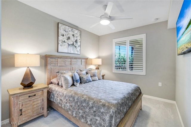 bedroom with light colored carpet, baseboards, and ceiling fan