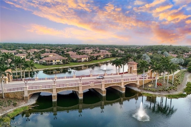 drone / aerial view with a water view and a residential view