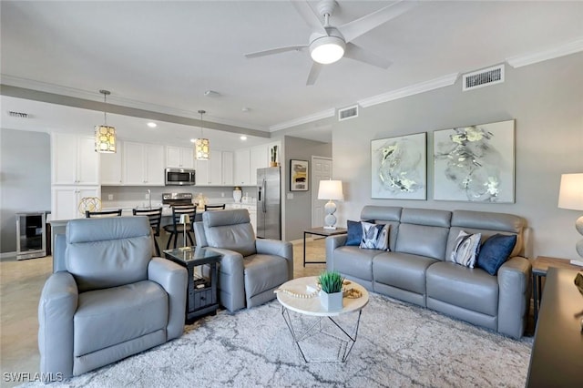 living area featuring visible vents, crown molding, and ceiling fan
