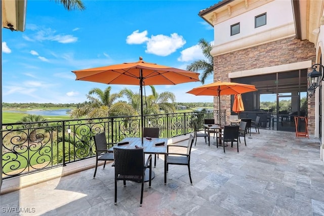 view of patio featuring outdoor dining space and a water view