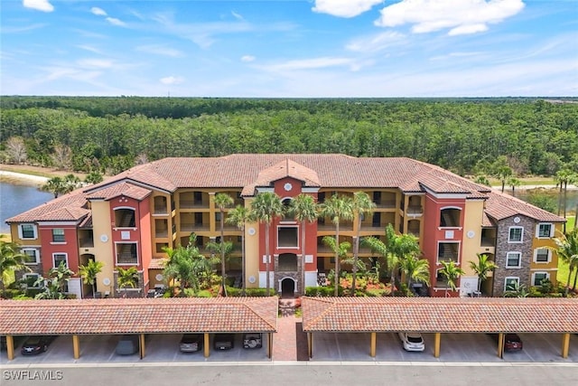 view of property featuring a wooded view