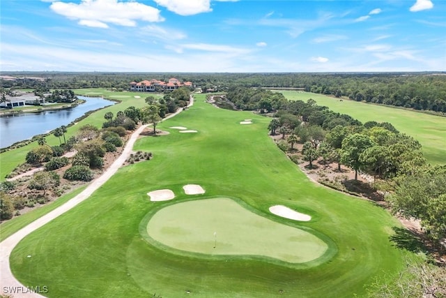 birds eye view of property featuring view of golf course and a water view