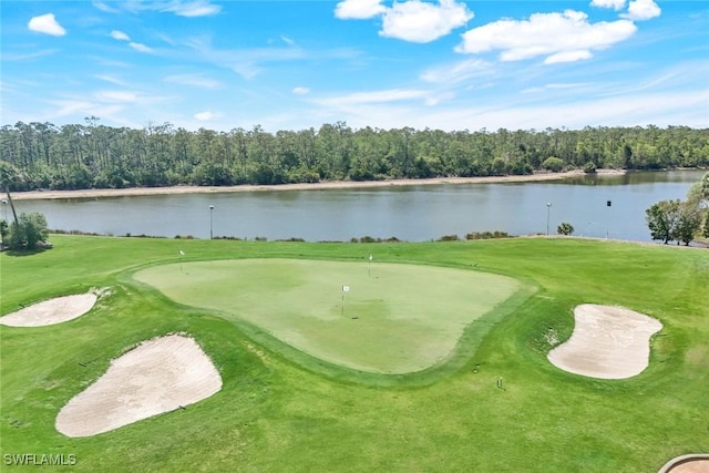 view of home's community with a lawn, a water view, and golf course view