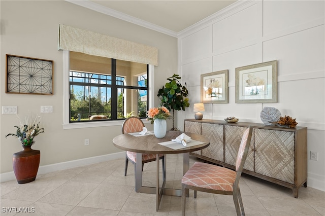 dining space featuring crown molding, baseboards, and light tile patterned flooring