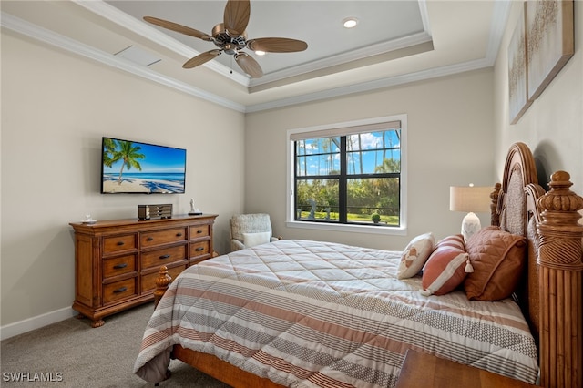 bedroom with ornamental molding, baseboards, light colored carpet, a raised ceiling, and a ceiling fan