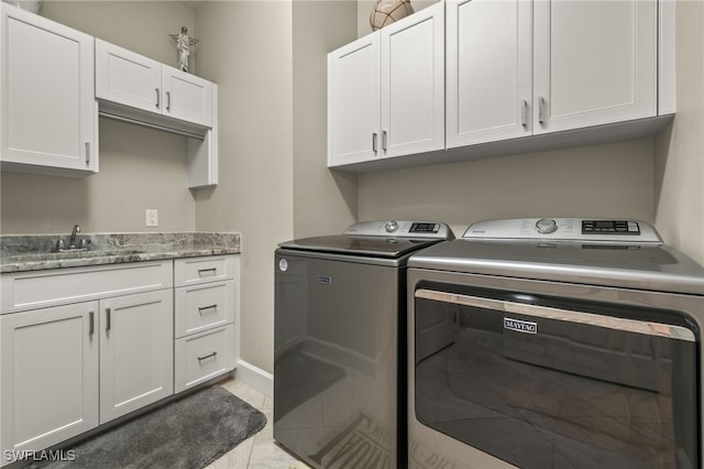 laundry room with a sink, separate washer and dryer, baseboards, and cabinet space