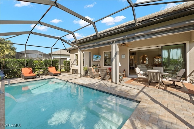 back of property featuring glass enclosure, stucco siding, a patio area, and an outdoor pool