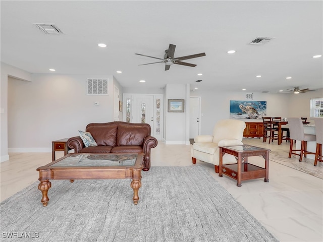living area with ceiling fan, recessed lighting, and baseboards
