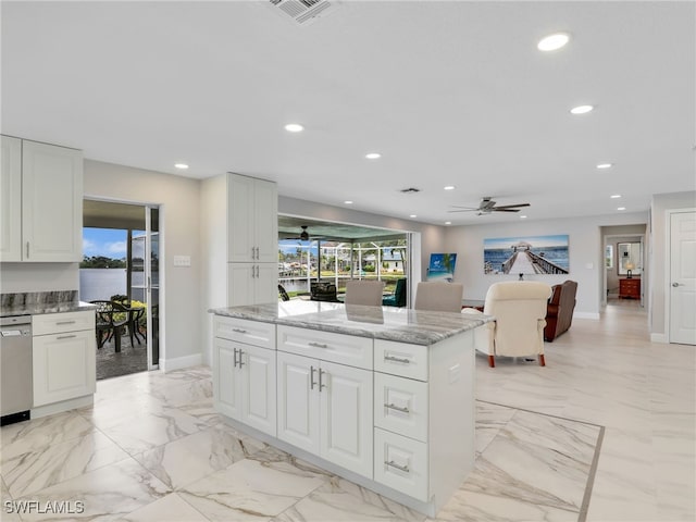 kitchen featuring ceiling fan, recessed lighting, plenty of natural light, white cabinetry, and light stone counters