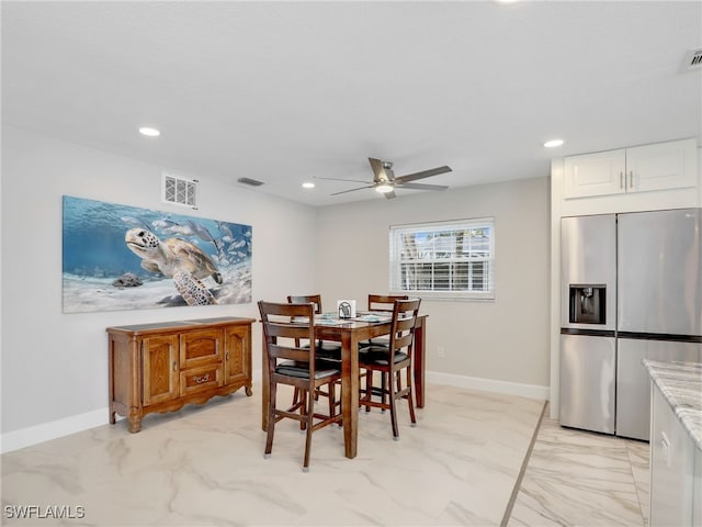 dining space with light marble finish flooring, a ceiling fan, recessed lighting, and baseboards