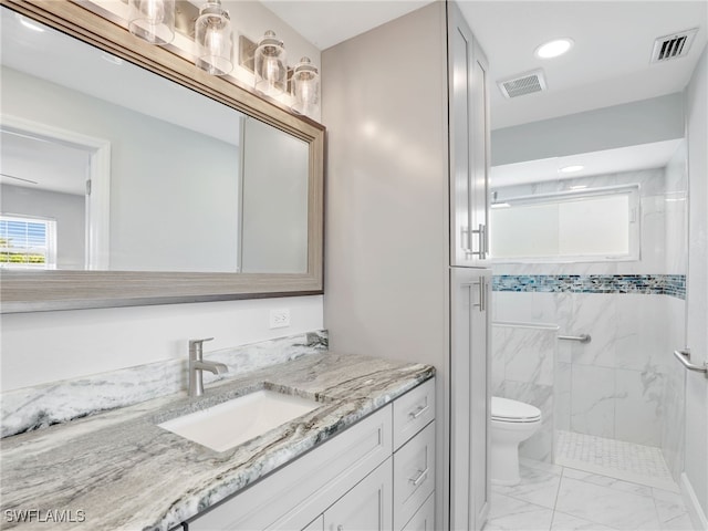 full bath with marble finish flooring, a marble finish shower, toilet, vanity, and recessed lighting
