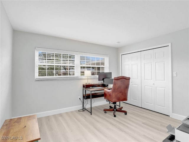 office space with wood finished floors and baseboards