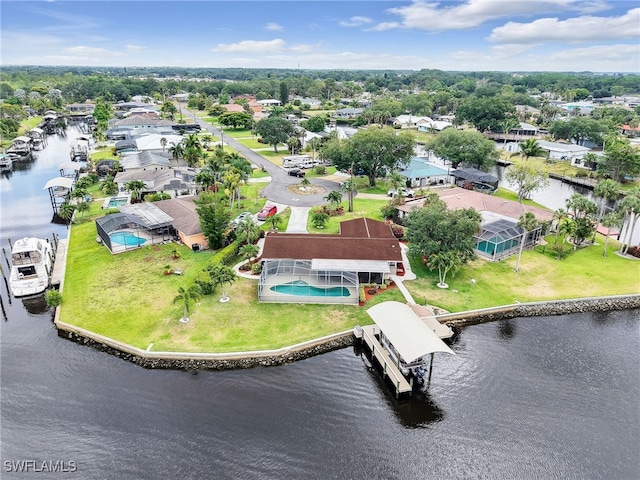 aerial perspective of suburban area with a nearby body of water and a pool area