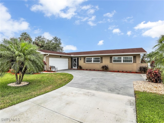 ranch-style house featuring a front yard, concrete driveway, an attached garage, and stucco siding