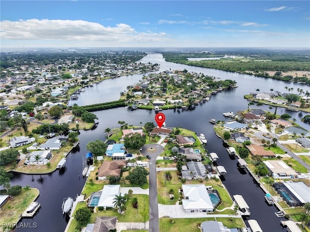 aerial view of property's location featuring a large body of water and nearby suburban area