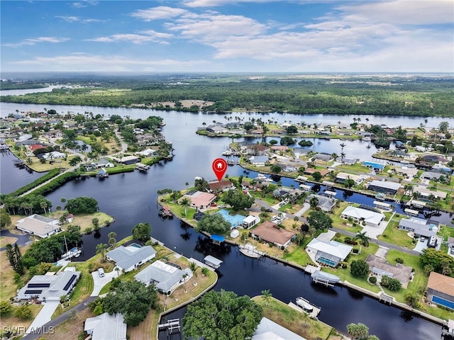 aerial view of property's location featuring a nearby body of water and nearby suburban area