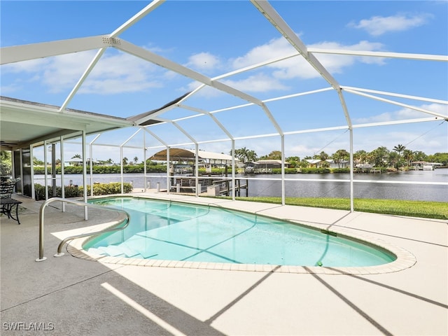 outdoor pool featuring a patio area, a water view, and a lanai
