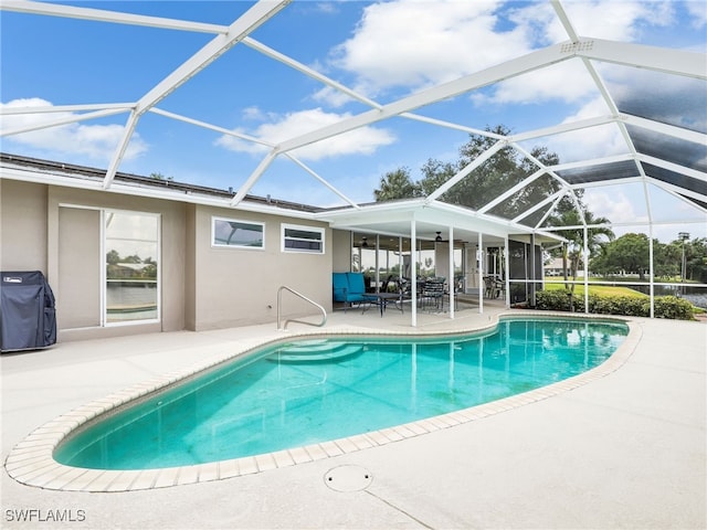 swimming pool featuring a patio area, glass enclosure, and grilling area