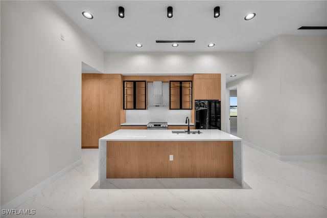 kitchen with range hood, modern cabinets, a sink, black fridge, and recessed lighting