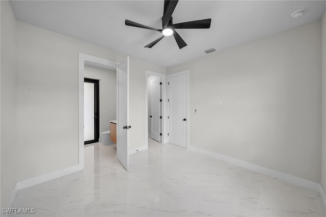 spare room with baseboards, visible vents, a ceiling fan, and marble finish floor