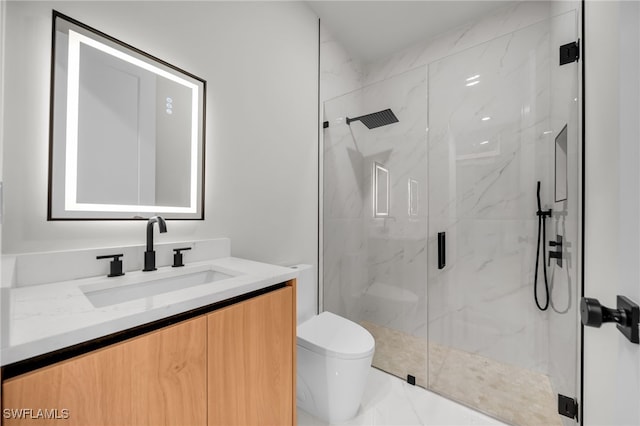 bathroom with a marble finish shower, vanity, and toilet
