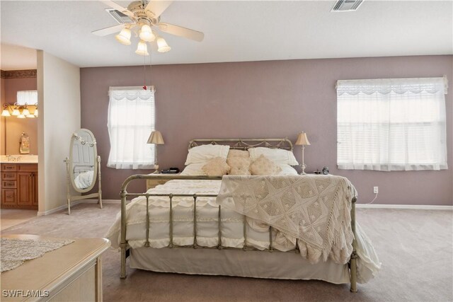 20849 Santorini Way N, Fort Myers, FL 33917 - bedroom featuring light colored carpet, a ceiling fan, baseboards, ensuite bathroom, and visible vents