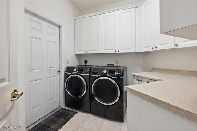 20849 Santorini Way N, Fort Myers, FL 33917 - laundry room featuring cabinet space, light tile patterned flooring, and washer and clothes dryer