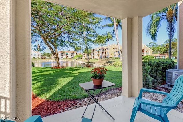 view of patio with a water view and central AC