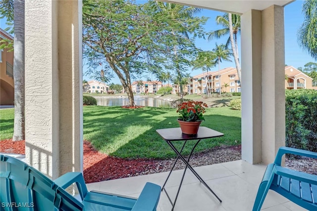 view of patio with a water view