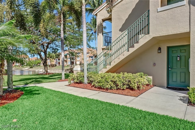 view of yard with a water view and stairway
