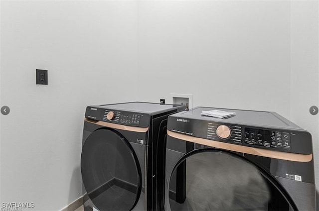 laundry area featuring baseboards, laundry area, and washer and clothes dryer