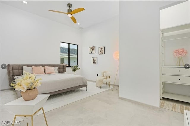 bedroom with baseboards, ceiling fan, and a towering ceiling