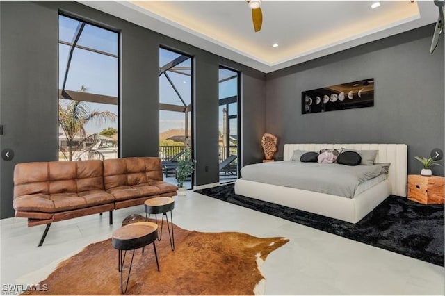 bedroom featuring access to outside, concrete flooring, and ceiling fan
