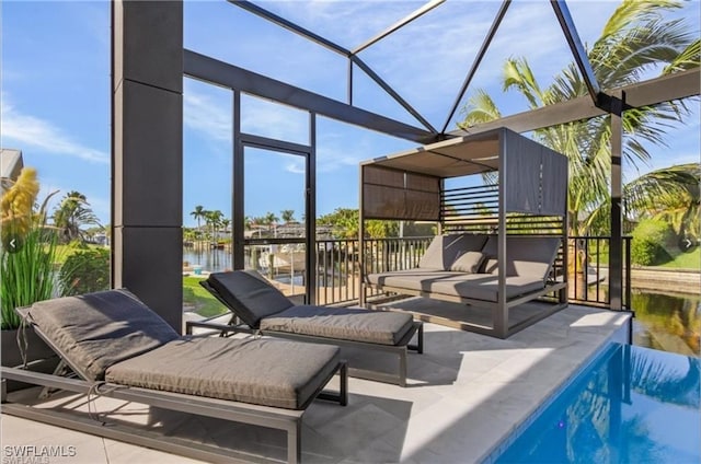 exterior space with glass enclosure, a water view, and an outdoor pool