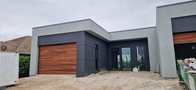 exterior space featuring an attached garage and stucco siding