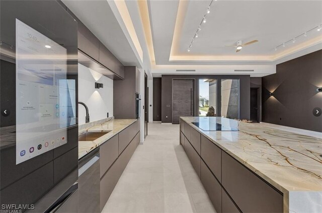 kitchen featuring rail lighting, a sink, modern cabinets, and stainless steel appliances