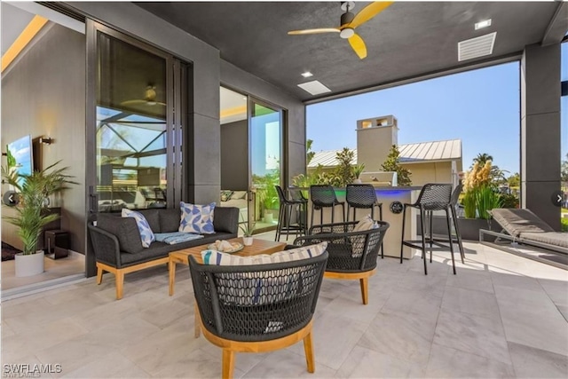 exterior space with an outdoor hangout area, ceiling fan, visible vents, and outdoor dry bar