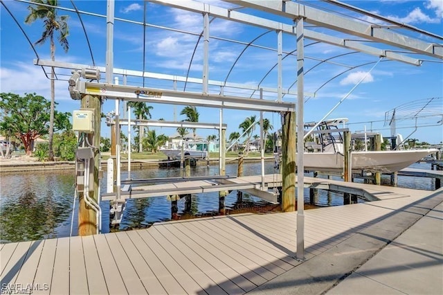view of dock featuring boat lift and a water view