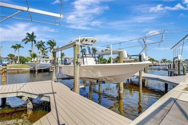 dock area with a water view and boat lift